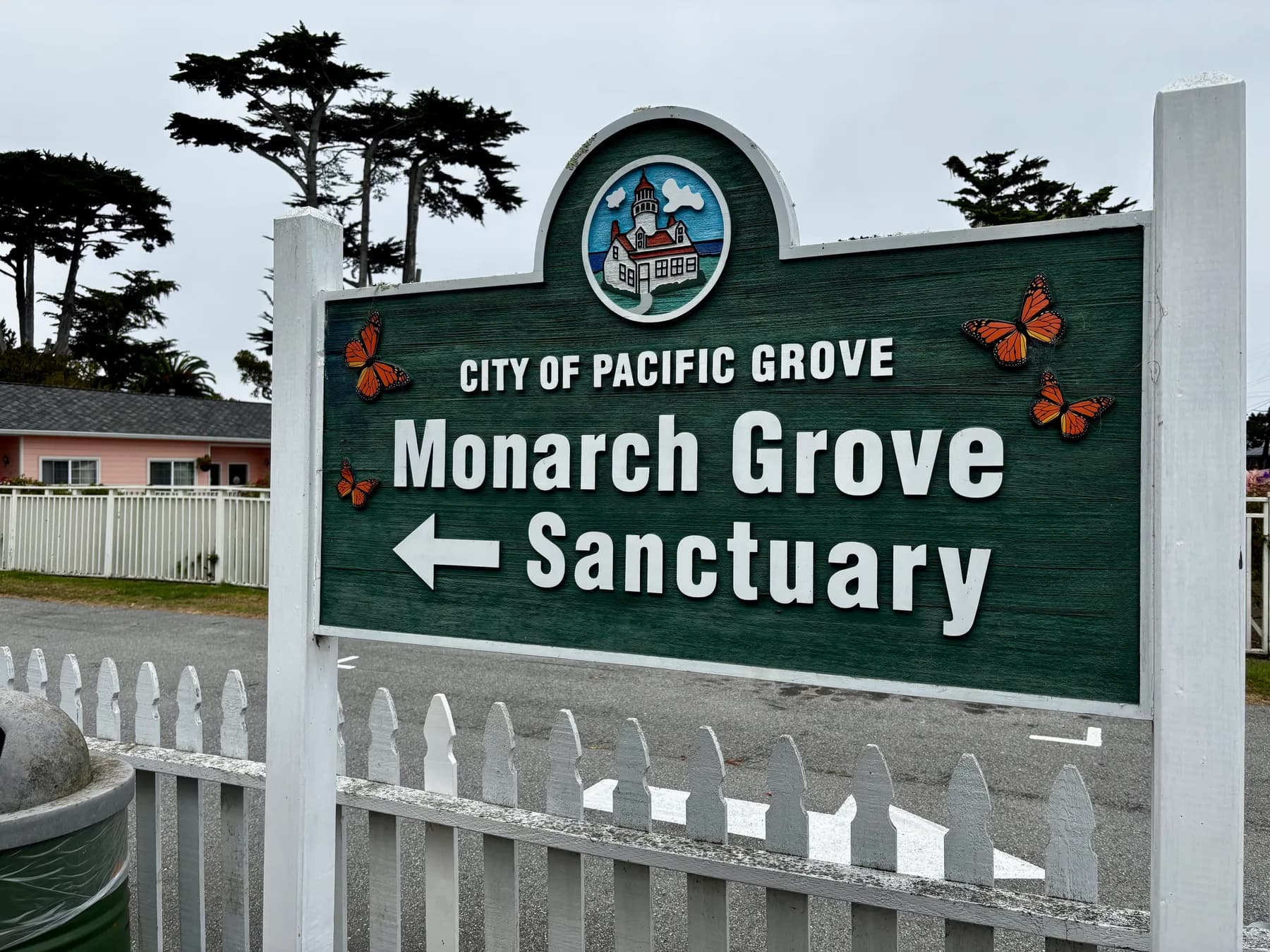 City of Pacific Grove Monarch Grove Sanctuary sign decorated with monarch butterflies