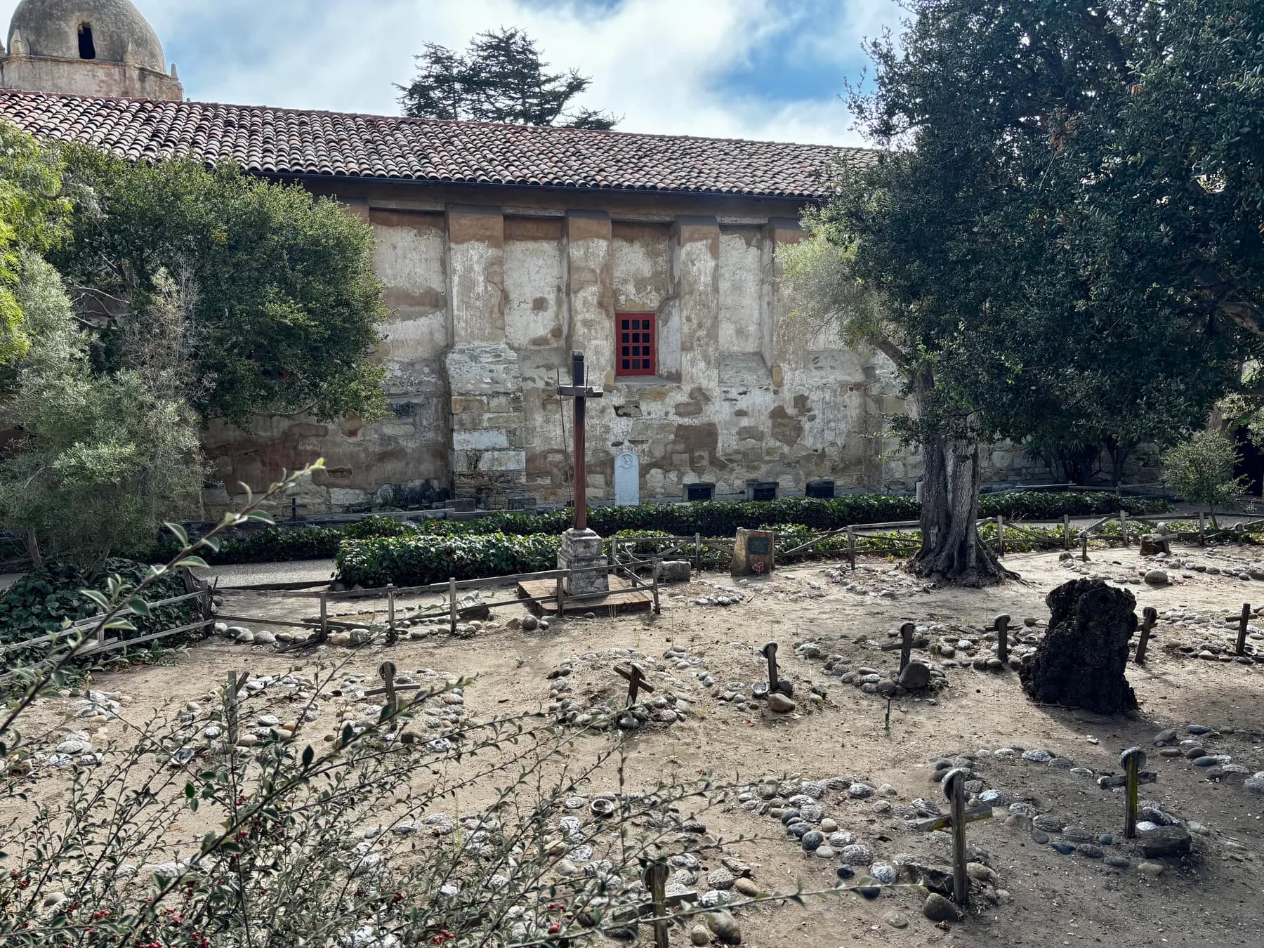 Weathered adobe wall and garden on the grounds of Carmel Mission