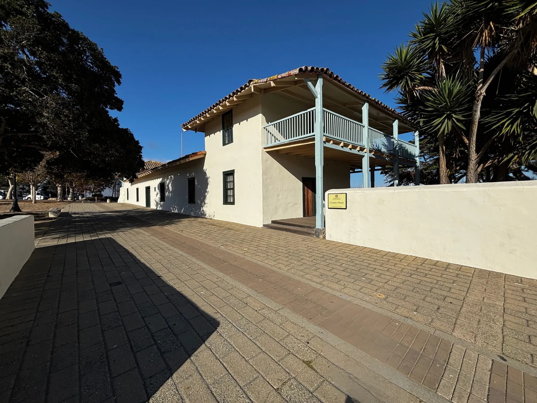 The Custom House in Monterey, a white two-story adobe with a wooden balcony